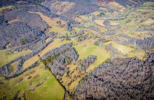 aerial view of property, mountain views, pastures, trees