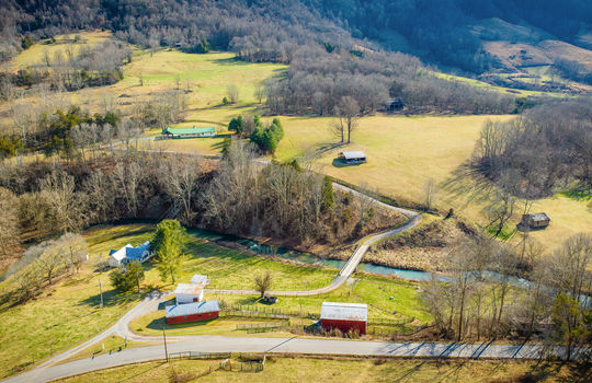 aerial view of property, main home, barns, secondary homes, creek, bridge,