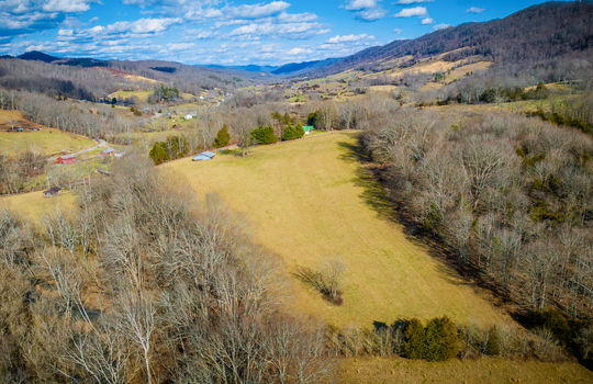 aerial view, barn, pasture, fence, mountain views, trees
