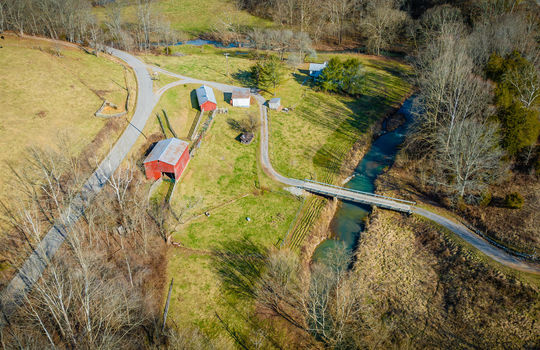 aerial view of property, creek, bridge, barns, driveway