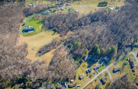 aerial view of property, brick home, paved driveway, 25.72+/- acres, trees