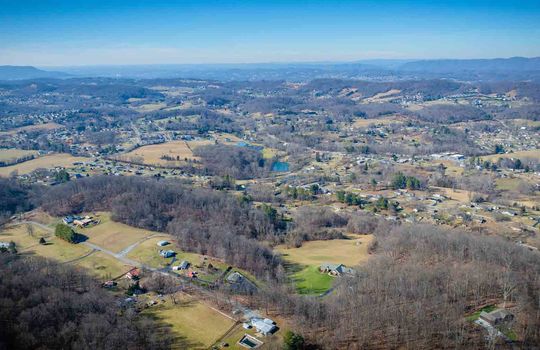 aerial view of property, trees, mountains, horizon