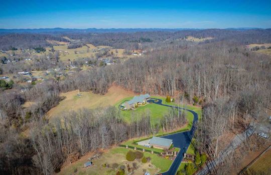 aerial view 25.72+/- acres, brick home, garages, paved driveway