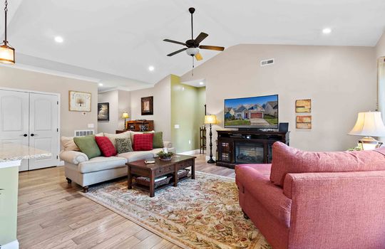 living room, vaulted ceiling, luxury vinyl flooring, picture window, hallway