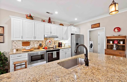 kitchen, granite countertops, kitchen island, sink, stainless appliances, cabinets, microwave, range/oven, refrigerator, recessed lighting