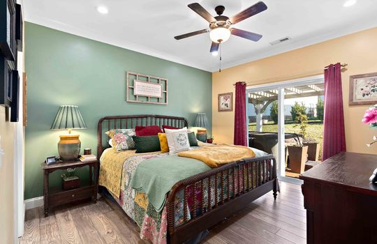 bedroom, luxury vinyl flooring, ceiling fan, sliding door to rear patio