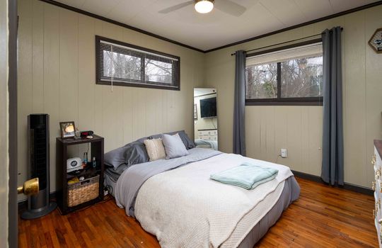 primary bedroom, hardwood flooring, ceiling fan, windows