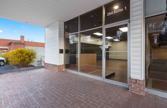 Glass door storefront, commercial property for lease , brick floored entryway