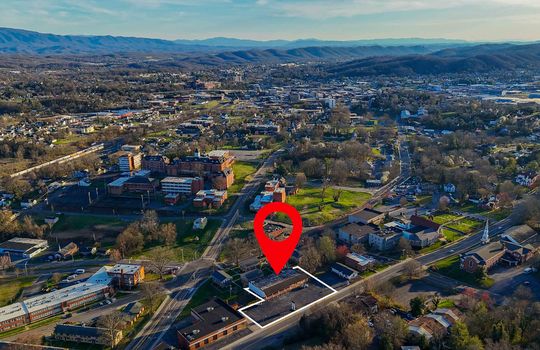 Aerial view of commercial property, mountains, surrounding businesses/neighborhood