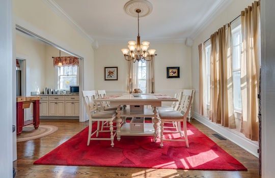 dining room, chandelier, hardwood flooring, windows, entry to kitchen