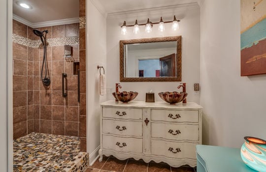 primary bathroom, tile shower, dual vanity, tile flooring