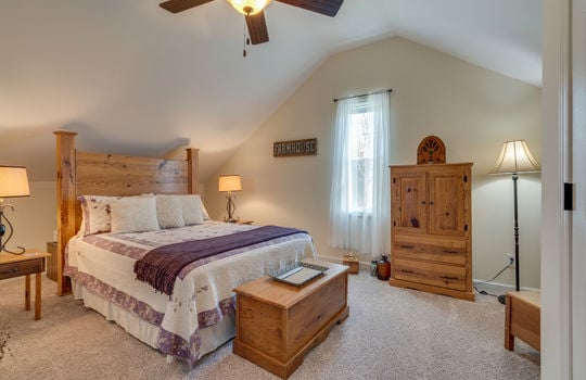 upper level bedroom, slanted ceiling, ceiling fan, carpet, window