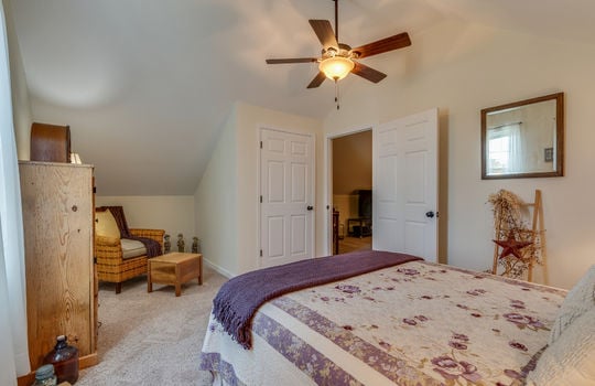 upper level bedroom, slanted ceiling, ceiling fan, carpet, window, closet
