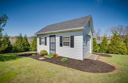 storage house, garage door, landscaping, yard, exterior entry