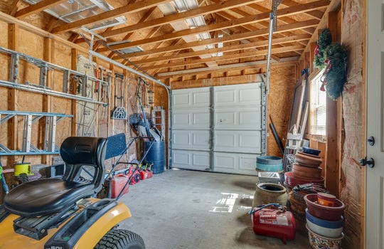 storage house interior, garage door, concrete flooring