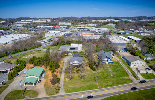 aerial view of home, road, neighboring properties