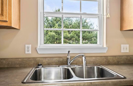 kitchen sink, faucet, window above sink,