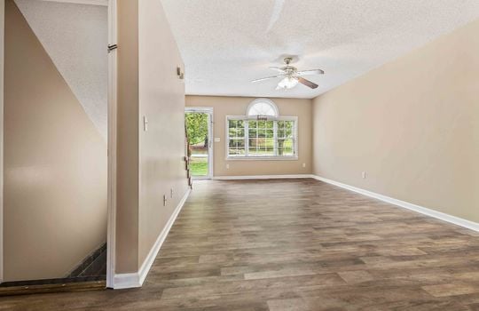 living room, luxury vinyl flooring, front door, ceiling fan, picture window