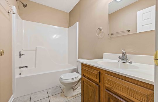 full bathroom, shower/tub, toilet, sink, tile flooring