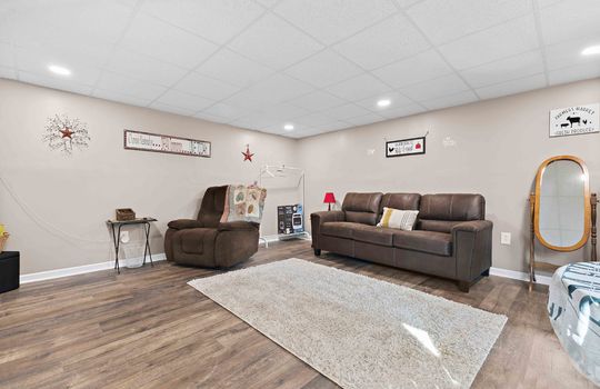 Guest home living room, luxury vinyl flooring, recessed lighting, ceiling tiles