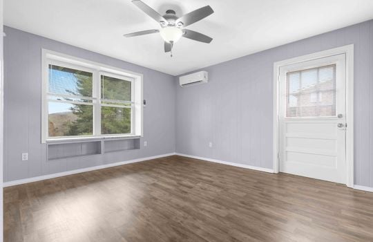 bedroom, luxury vinyl flooring, exterior door, ceiling fan, window