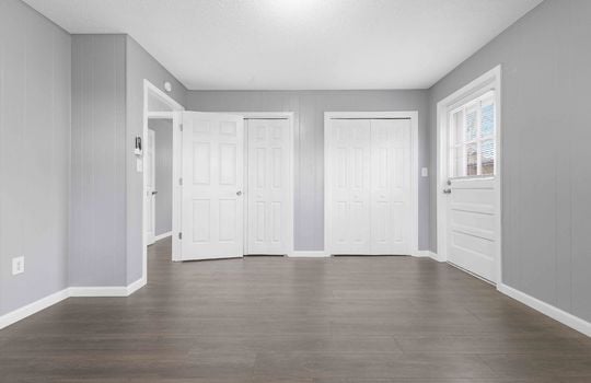 bedroom, exterior doorway, double closets, luxury vinyl flooring