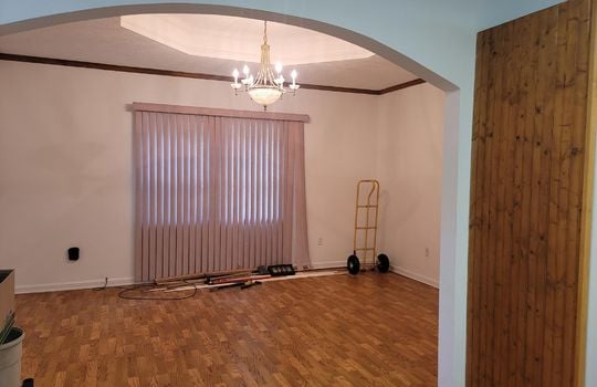 dining room, arched doorway, window, wood trim, chandelier