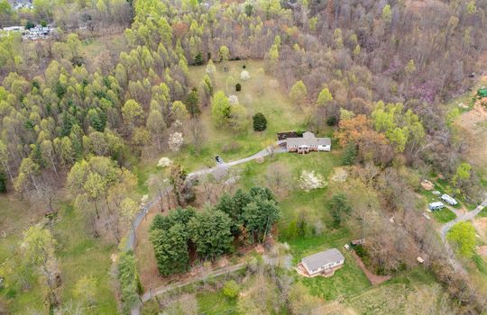 aerial view, home and 8.1+/- acres, trees, driveway, home, neighboring home