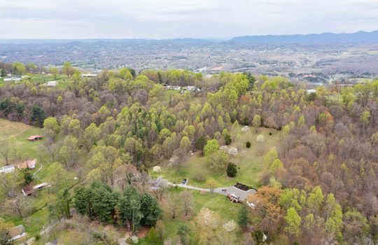aerial view, home and 8.1+/- acres, trees, driveway, home, neighboring home, mountain views