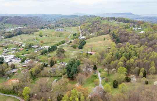 aerial view, home and 8.1+/- acres, trees, driveway, home, neighboring home, mountain views