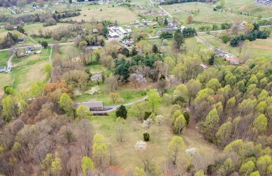 aerial view, home and 8.1+/- acres, trees, driveway, home, neighboring homes, road