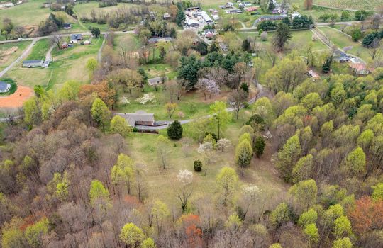 aerial view, home and 8.1+/- acres, trees, driveway, home, neighboring homes, road
