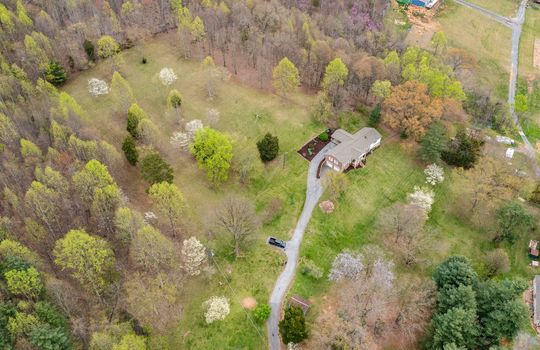 aerial view, home and 8.1+/- acres, trees, driveway, home