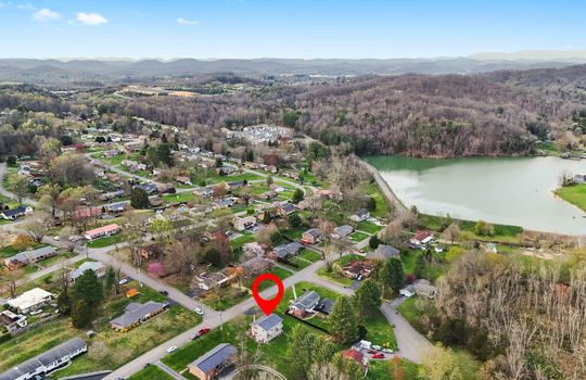 aerial view of property, road, neighborhood, property marker, water, mountain views