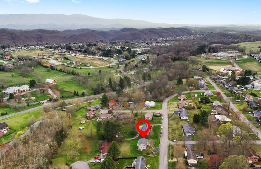 aerial view of property, road, neighborhood, property marker, water, mountain views