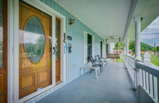 front porch, covered front porch, front door, vinyl siding, concrete floor