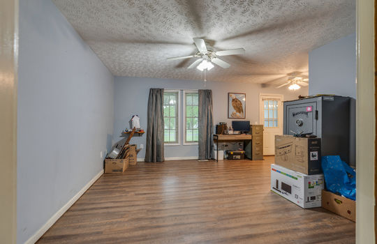 primary suite, vinyl flooring, ceiling fan, windows, exterior door