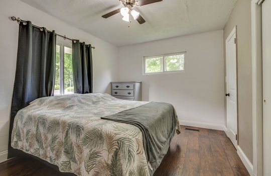 bedroom, luxury vinyl flooring, ceiling fan, windows