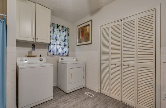 primary suite, laundry area, closet/storage, vinyl flooring