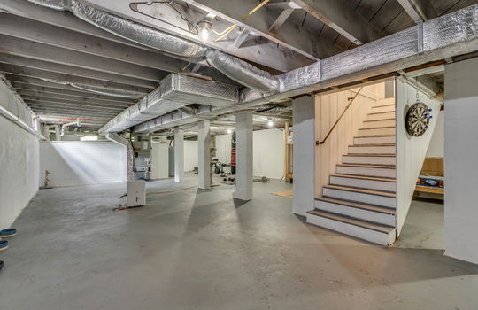 full unfinished basement, concrete flooring, stairs to main level