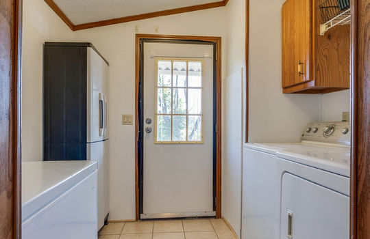 laundry room/mud room, exterior door, tile, washer/dryer hookups, cabinets