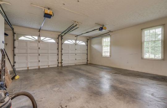 garage, concrete flooring, garage doors, windows