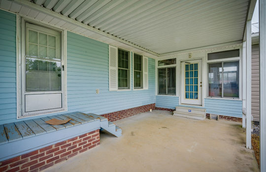 covered back porch, exterior doors, concrete patio, vinyl siding