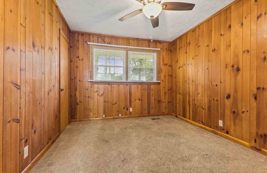 bedroom, closet, knotty pine walls, ceiling fan, carpet, windows