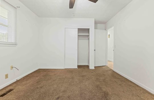 bedroom, carpet, ceiling fan, closet, door to hallway
