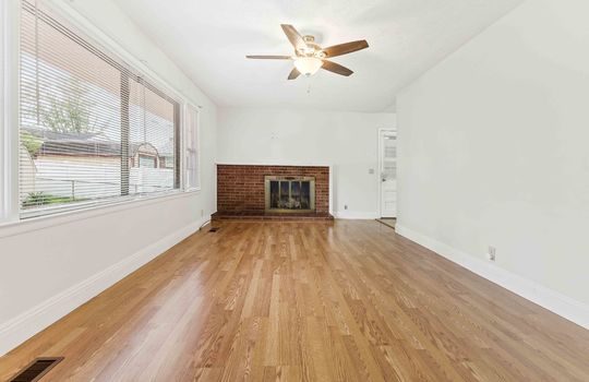 living room, picture window, hardwood flooring, ceiling fan, fireplace, exterior door