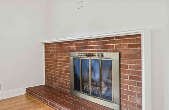 living room fireplace, hardwood flooring, brick fireplace