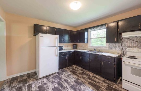 Kitchen, vinyl flooring, refrigerator, cabinets, countertops, sink, window above sink