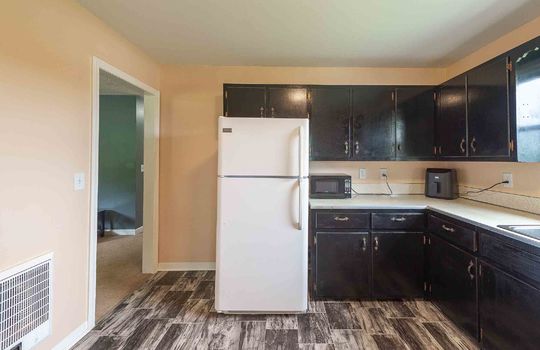 kitchen, refrigerator, cabinets, countertops, sink, window above sink, vinyl flooring