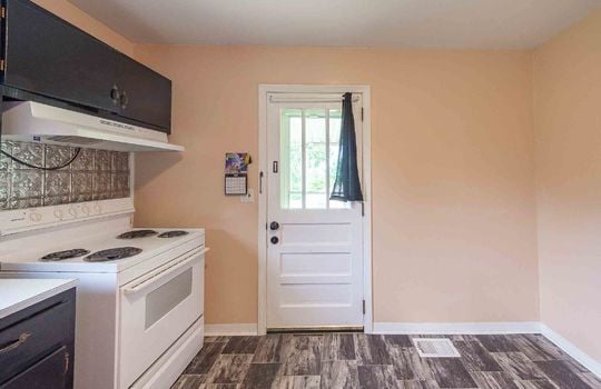 Kitchen, vinyl flooring, range/oven, cabinets, exterior door